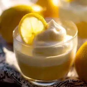 Quick & Creamy Lemon Mousse – No-Bake, Egg-Free & Ready in Minutes! 5 Close-up of creamy lemon mousse topped with whipped cream and fresh lemon slice