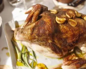 Garlic Herb Butter Roasted Turkey with golden skin and herbed butter underneath the skin