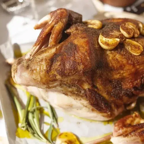 Garlic Herb Butter Roasted Turkey with golden skin and herbed butter underneath the skin