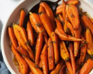 Brown Sugar Glazed Carrots with Candied Pecans served in a dish.