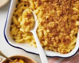 Creamy butternut squash mac and cheese dish topped with breadcrumbs and cheese.