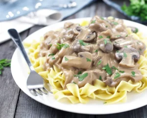 Easy Ground Beef Stroganoff served over egg noodles with mushrooms and sour cream sauce.