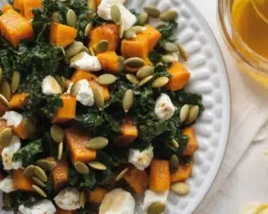 Kale salad with butternut squash, goat cheese, and apricot vinaigrette.