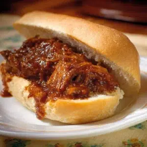 Delicious leftover pork tenderloin sandwich on a plate with fresh ingredients