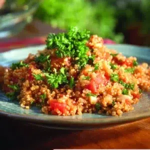 A vibrant dish of Mexican Quinoa with Chicken, garnished with fresh vegetables.