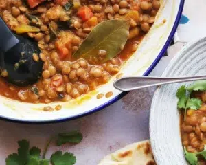 Cozy butternut squash lentil stew with vegetables and spices served in a bowl.