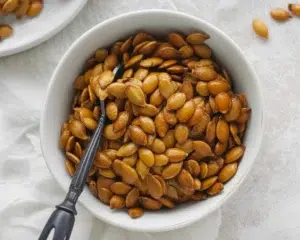 Crunchy sriracha pumpkin seeds roasted with honey for a spicy snack.