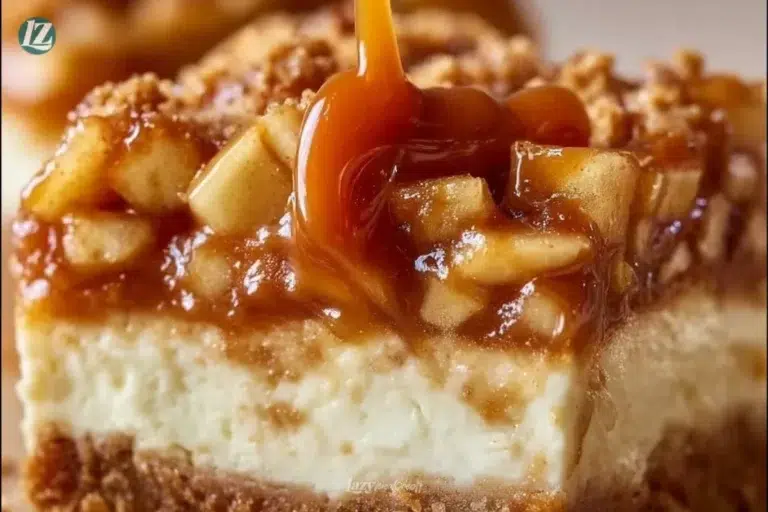 Caramel apple cheesecake bars topped with caramel and apple slices.