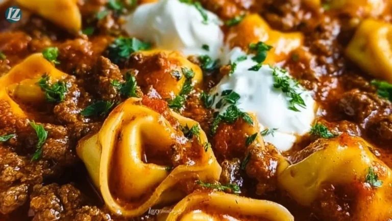 Cheesy beef enchiladas tortellini in a baking dish topped with cheese and cilantro