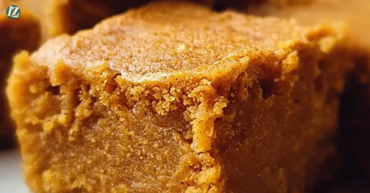 Deliciously moist pumpkin maple blondies served on a plate with autumn leaves.