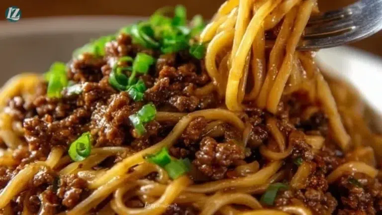 Delicious plate of Mongolian ground beef noodles with fresh vegetables.