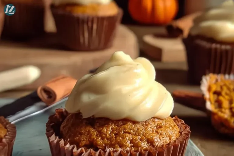 Delicious pumpkin cupcakes with cream cheese frosting on a rustic wooden table
