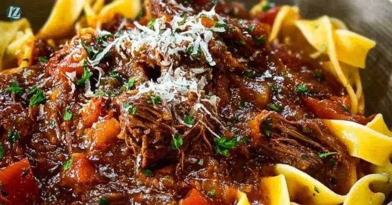 Slow cooked beef ragu served over pasta in a bowl