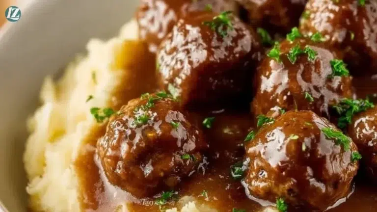 Slow cooker Salisbury steak meatballs served with gravy over mashed potatoes.