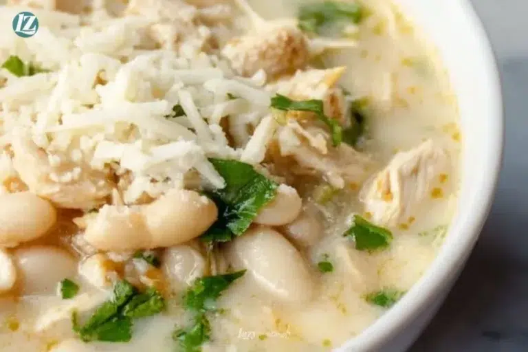 Bowl of creamy white chicken chili topped with cilantro and jalapeños