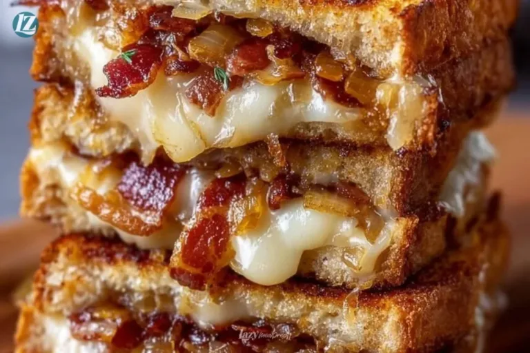 Bacon and caramelized onion grilled cheese sandwich on a wooden board