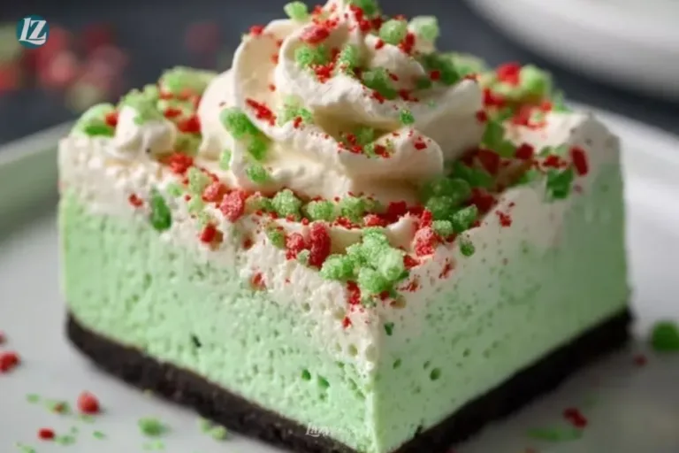 A delicious No Bake Grinch Christmas Cheesecake decorated with green and red toppings.