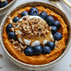 Colorful sweet potato breakfast bowl with toppings and healthy ingredients.