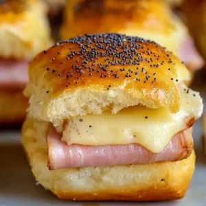 Ham and Havarti Cheese Sliders on a plate with herbs
