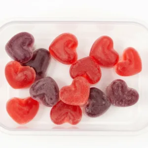 Delicious homemade fruit gummies in vibrant colors on a wooden table.