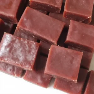 Homemade berry gelatin squares served on a plate, perfect for family snacks.