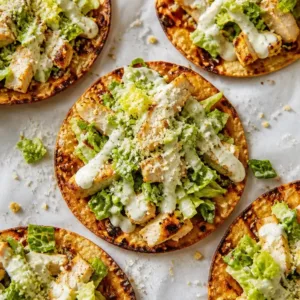 Delicious Chicken Caesar Tacos served on a plate with fresh ingredients.