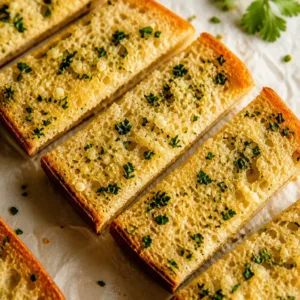 Delicious homemade garlic bread with a buttery garlic herb spread, baked until crispy.